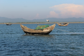 Naklejka na ściany i meble Fishing boats in Bay of Bengal Bangladesh Burma Border with a Seagal flying 