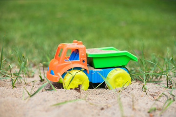 toy truck on the grass and sand
