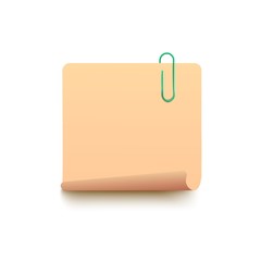 Blank yellow sticky note with curled bottom corner with green paperclip