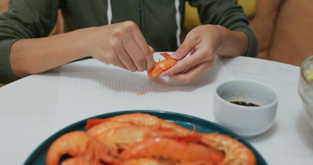 Woman eat shrimp at home