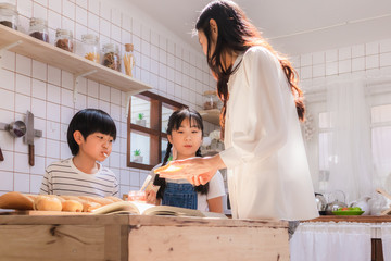 Happy and cute Asian family making food in kitchen at home together