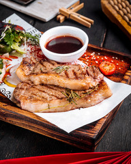 Grilled juicy steak sauce salad on wooden board