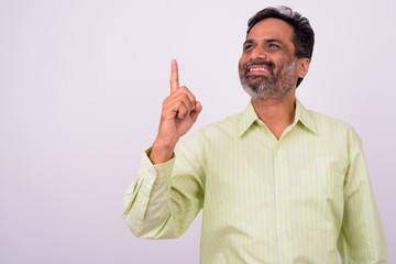 Fototapeta premium Portrait of happy mature handsome bearded Indian businessman