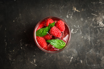 Raspberry and mint cocktail in glass on the rustic background. Selective focus. Shallow depth of field.