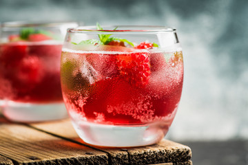 Raspberry and mint cocktail in glass on the rustic background. Selective focus. Shallow depth of field.