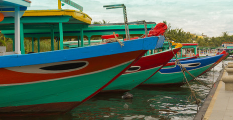 Colorful traditional tour boats moored along the river in Hoi An Vietnam