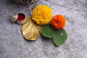 Dussehra or Vijay dashmi greeting , green leaf, marigold flowers and kumkum.