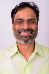 Fototapeta premium Portrait of happy mature handsome bearded Indian businessman