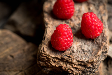 Ripe raspberry on the wooden plank. Selective focus. Shallow depth of field.
