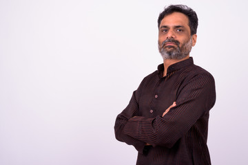 Portrait of mature handsome bearded Indian businessman