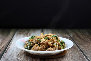 Traditional fried and stirred minced pork, chilly and basil, seasoning with fish sauce and sugar. Famous Thai spicy street food menu in Thailand. Quick and easy meal in rush hour. Comfort food. 