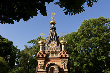 A fragment of an Orthodox chapel on the background of blue sky.