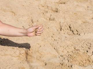 Sand falling from a woman's hand i