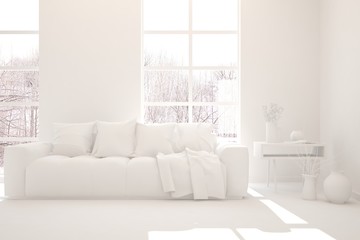 Fototapeta premium White stylish minimalist room in grey color with sofa and winter landscape in window. Scandinavian interior design. 3D illustration