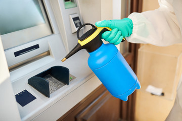 Close-up of ATM disinfection during coronavirus pandemic.