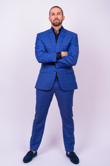 Portrait of handsome bald bearded businessman in suit