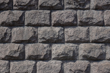 stone wall, cut stone masonry, granite basement of the building