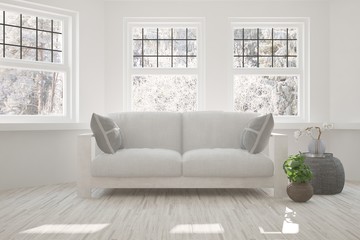 Fototapeta premium White stylish minimalist room with sofa and winter landscape in window. Scandinavian interior design. 3D illustration