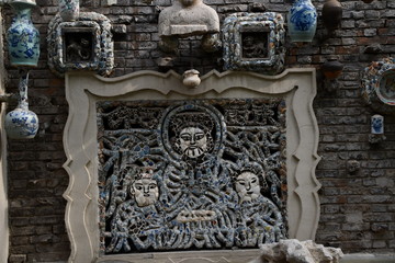 The picture made of porcelain on the wall of the chinese traditional authentic house in historical district of Tianjin covered with porcelain china