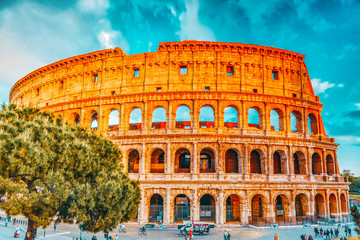 Fototapeta na wymiar ROME, ITALY- MAY 07, 2017: Beautiful landscape of the Colosseum in Rome- one of wonders of the world with tourist near it in the evening time.