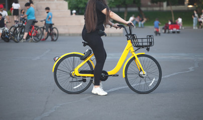 Naklejka premium Caucasian girl riding bicycle in city.