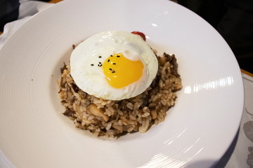 Brown Rice Risotto with baked beef, boiled mushroom. Beef fried rice with fried egg on top.