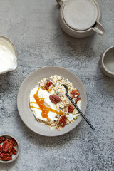 fresh oak granola with pecan nuts on concrete background