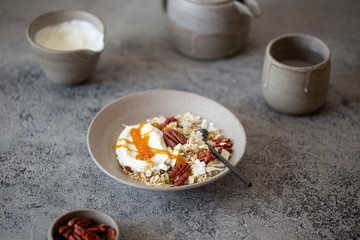 fresh oak granola with pecan nuts on concrete background