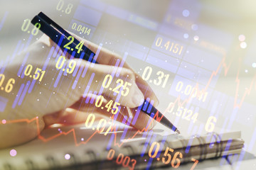 Double exposure of abstract creative financial diagram with hand writing in notebook on background, banking and accounting concept