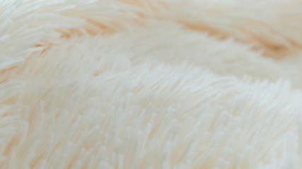 delicate soft background of plush fabric folds on white background. Copy space. Flat lay. loose folds on the fabric of faux fur of lilac color. Details of warm winter clothes