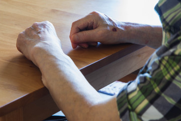 Obraz premium テーブルに手を置く老人男性1