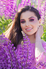 Summer portrait of perfect woman with colorful flowers smiling outdoors