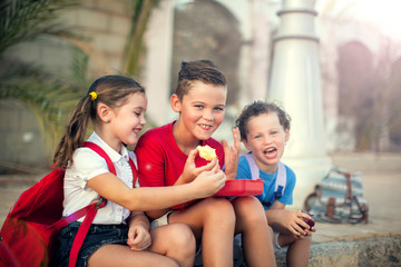 Pupils having lunch time outdoor. Children, education and nutrition concept