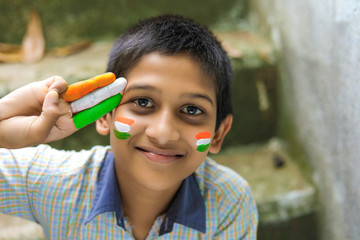 young indian child with indian flag on face