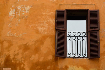 A Vintage Window with Rustic Orange Wall