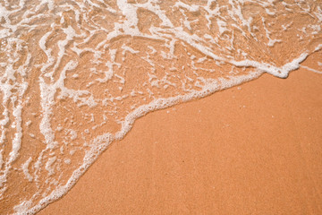 Tourist travel banner design template, copy space. White foam of a sea wave, golden sand beach, turquoise ocean water.