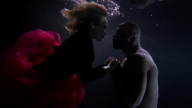 lovers are approaching and repelling each other underwater, love and hate, dating and breakup