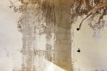 Background concrete wall, traces of weathering, worn wall damaged paint old paint. Remains of old paint on the painted concrete surface. Grungy destruction surface.