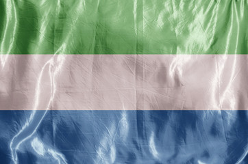 State flag fluttering in the wind. Colored background on textiles