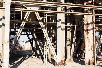 Old, abandoned concrete plant with iron rusty tanks and metal structures. The crisis, the fall of the economy, stop production capacity led to the collapse. Global catastrophe.