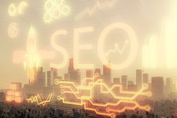 SEO hologram on city view with skyscrapers background double exposure. Search optimization concept.