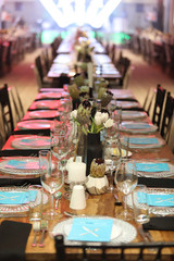 Gala dinner setup with white flowers and blue place cards.