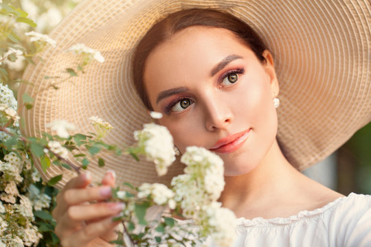 Beautiful spring woman with flowers, outdoor portrait