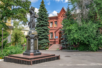 Fototapeta na wymiar Kharkiv, Ukraine - July 20, 2020: Jesus Christ statue with a book in front of Theological Seminary in Pokrovsky Monastery in Kharkov. Memorial sign to the 2000th anniversary of the Nativity of Christ