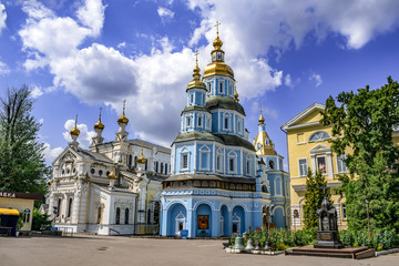 Fototapeta na wymiar Kharkiv, Ukraine - July 20, 2020: Pokrovsky Cathedral and Temple of the Mother of God Ozeryansky in the Holy Intercession Monastery in Kharkov. Orthodox monastery complex on a sunny summer day
