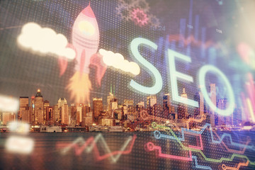 SEO hologram on city view with skyscrapers background double exposure. Search optimization concept.
