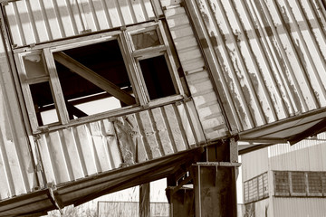 Old, abandoned concrete plant with iron rusty tanks and metal structures. The crisis, the fall of the economy, stop production capacity led to the collapse. Global catastrophe. Old photo effect