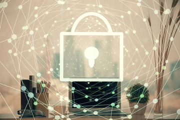 Double exposure of desktop with computer and lock icon hologram. Concept of data safety.