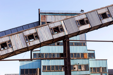 Old, abandoned concrete plant with iron rusty tanks and metal structures. The crisis, the fall of the economy, stop production capacity led to the collapse. Global catastrophe.