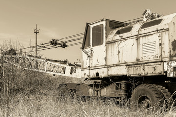 Naklejka premium Old rusty construction crane. Crisis in Ukraine, fall of economy, stop of production capacity. Global catastrophe.